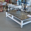 Transmission repair table with adjustable legs and perimeter oil drip trough.